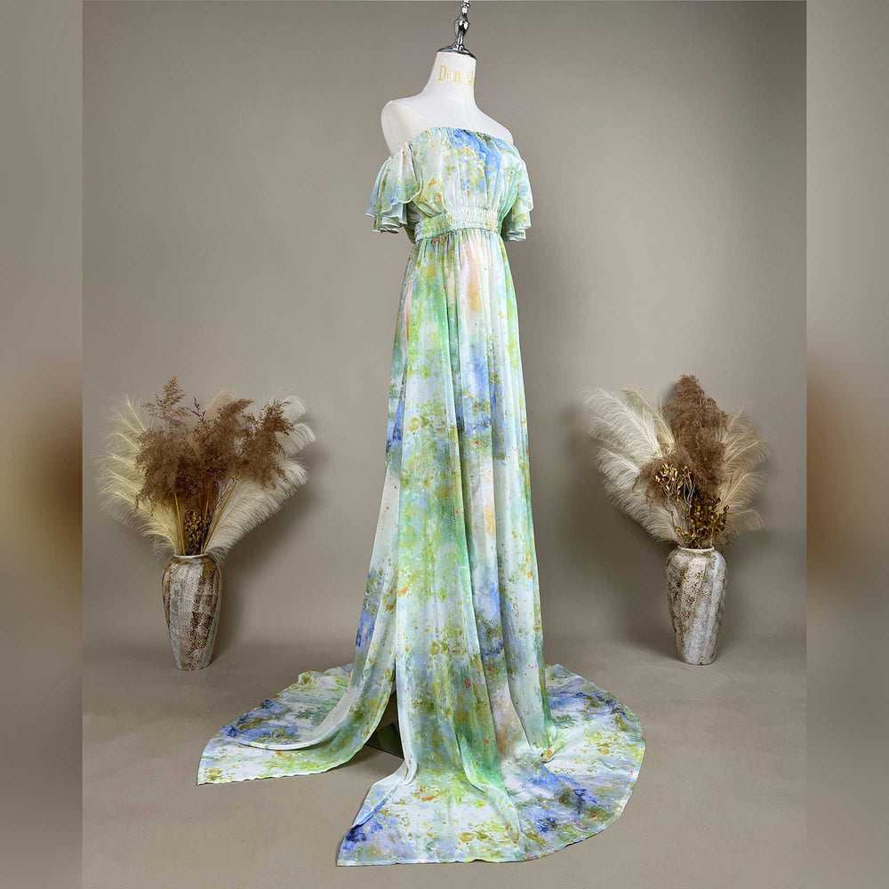 A side view of a mannequin displays a Achlys watercolor floral print maternity photography dress.