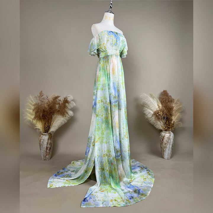 A side view of a mannequin displays a Achlys watercolor floral print maternity photography dress.