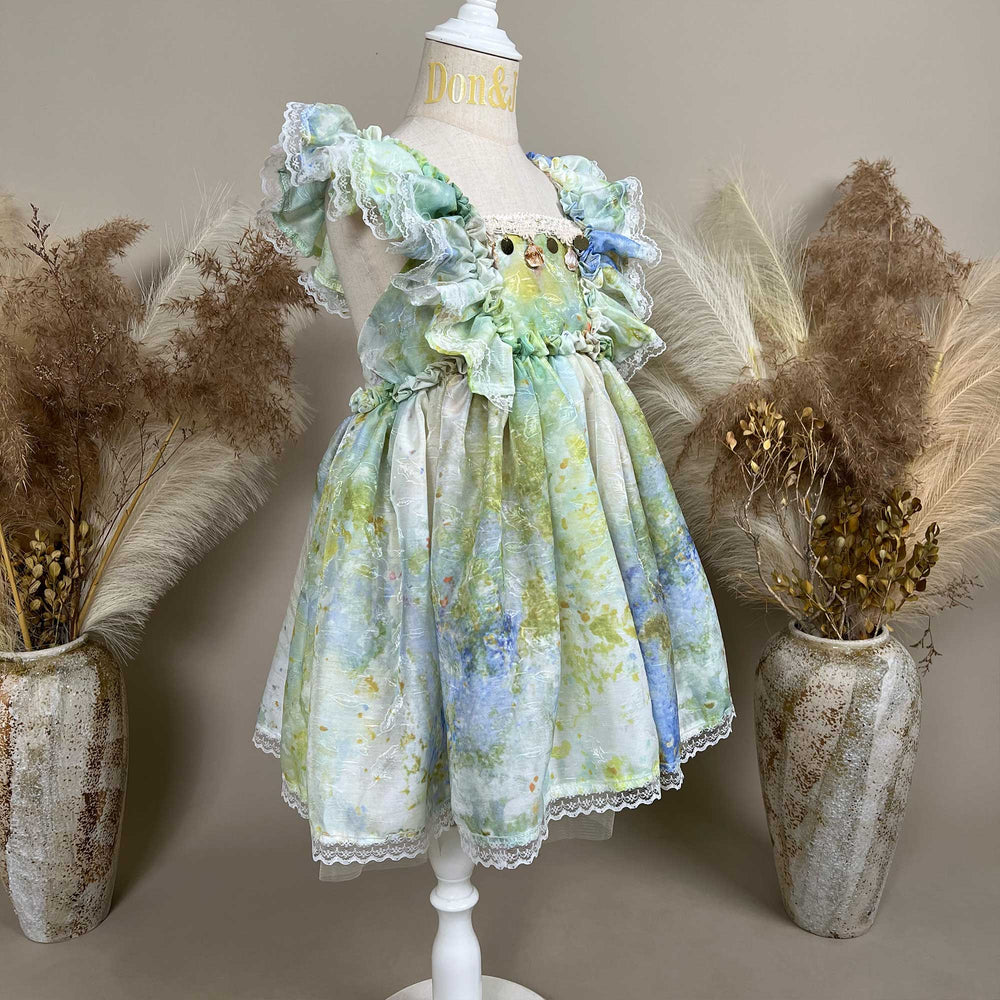 A side view of a mannequin displays an Adrasteia 3D floral lace trim dress. 