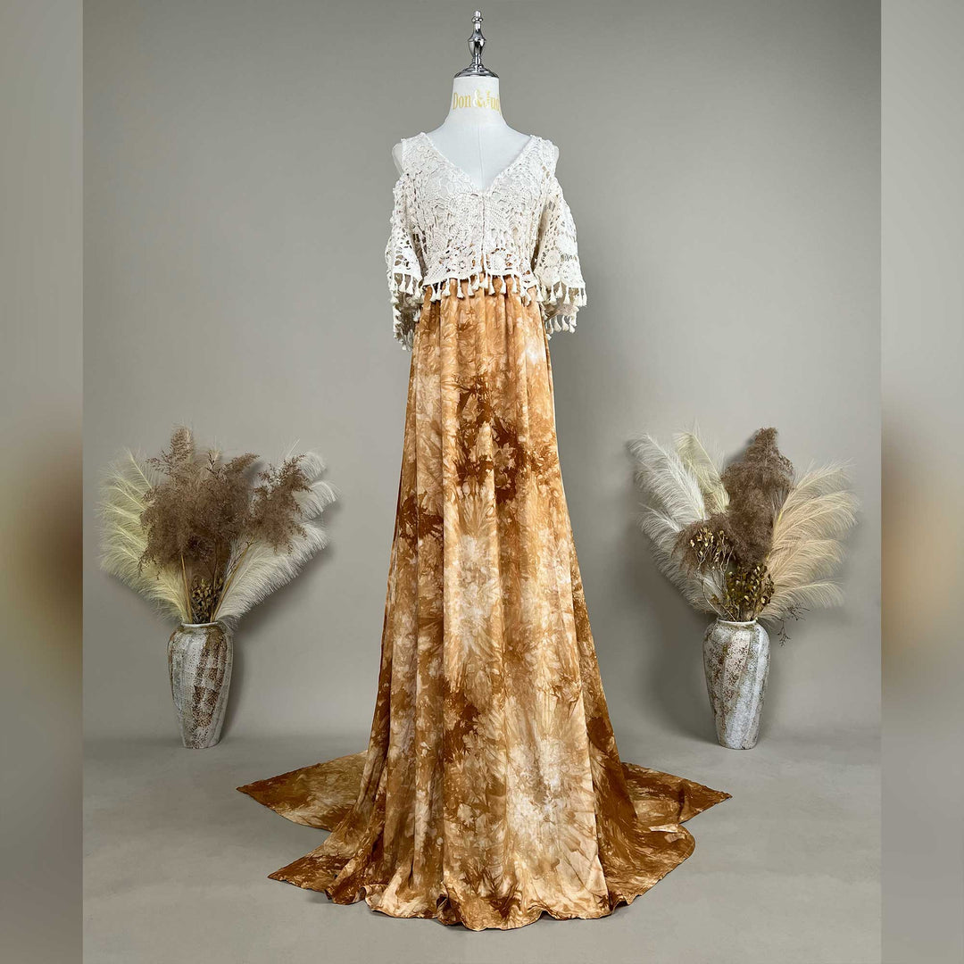 A mannequin displays an Aura tie-dye gown with a white crochet top; the dress features a train.