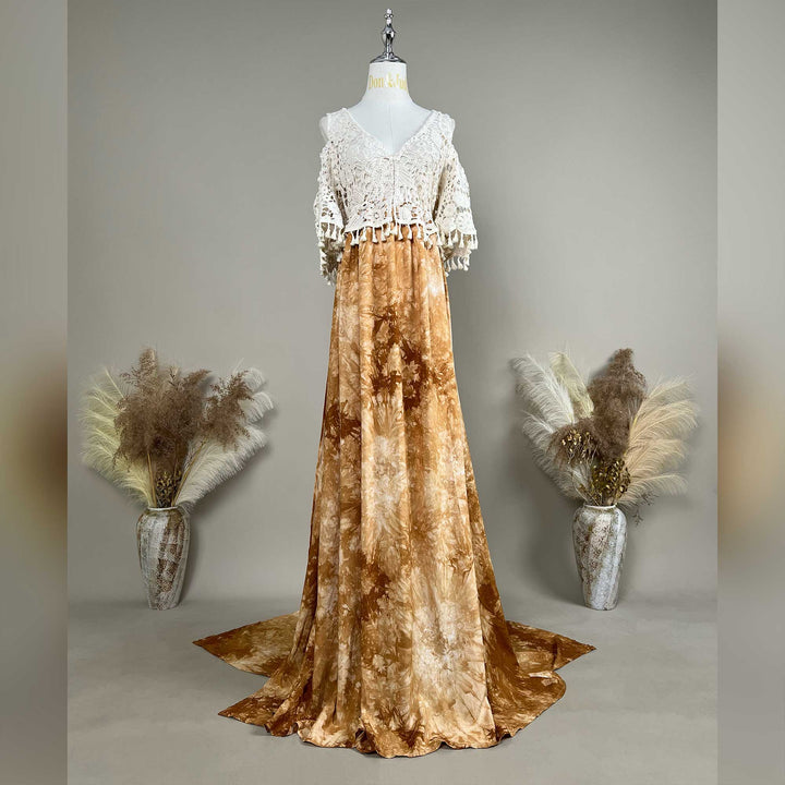 A mannequin displays an Aura tie-dye gown with a white crochet top; the dress features a train.