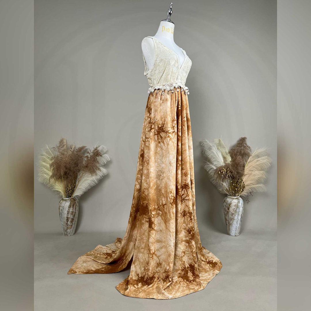 A white crochet top with an Aura tie-dye gown is displayed on a mannequin.