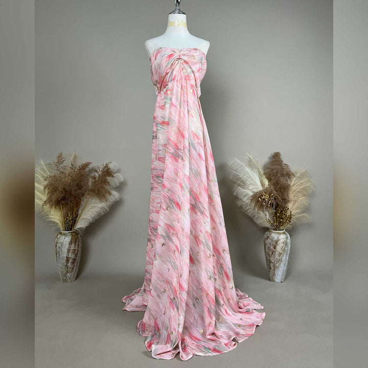A mannequin displays a Cybele pink printed strapless gown with pleats and a train.