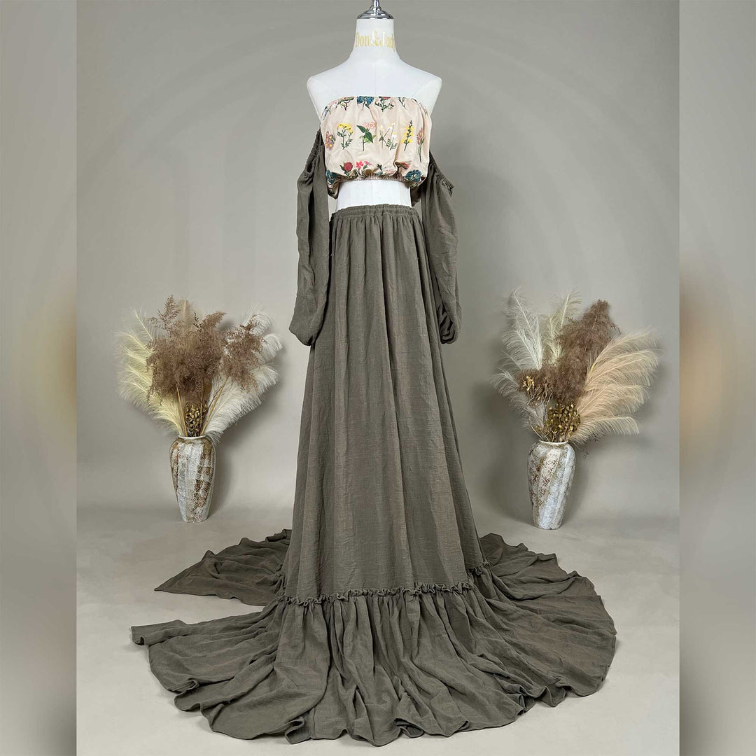 A mannequin displays a Freda floral top, olive skirt, and detached sleeves, with the skirt train on the ground.