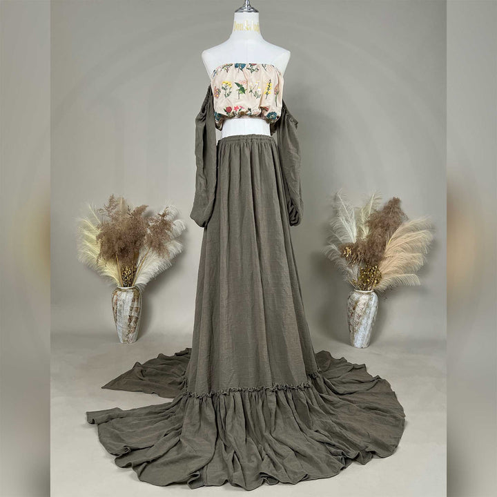 A mannequin displays a Freda floral top, olive skirt, and detached sleeves, with the skirt train on the ground.