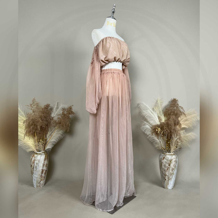A mannequin a side view of a Hecate two-piece maternity set featuring an off-shoulder top and floor-length tulle skirt.