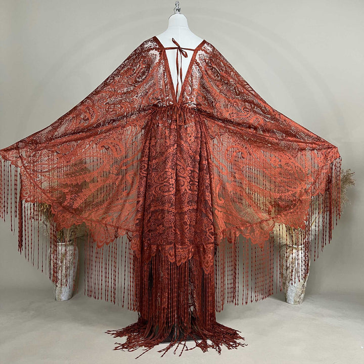 A mannequin displays a Hemera terracotta lace fringe robe with arms spread; the robe features a deep V-neck and wide sleeves