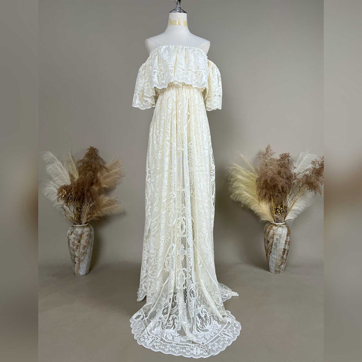A mannequin displays a Kymopoleia beige off-shoulder lace gown with ruffled sleeves and a train.