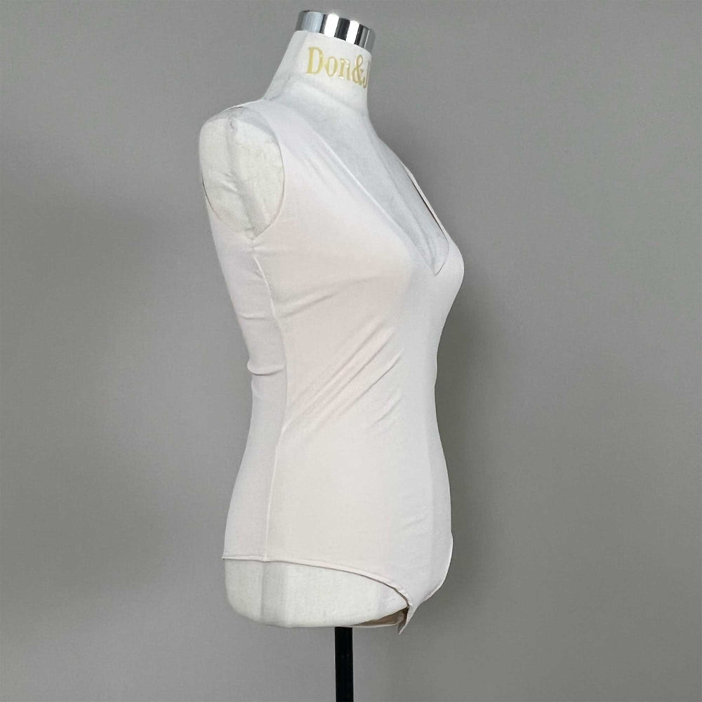 A mannequin shows a side view of a Medusa skin sleeveless bodysuit, revealing the V-neck silhouette and fitted cut; the hem features a curved high-cut design