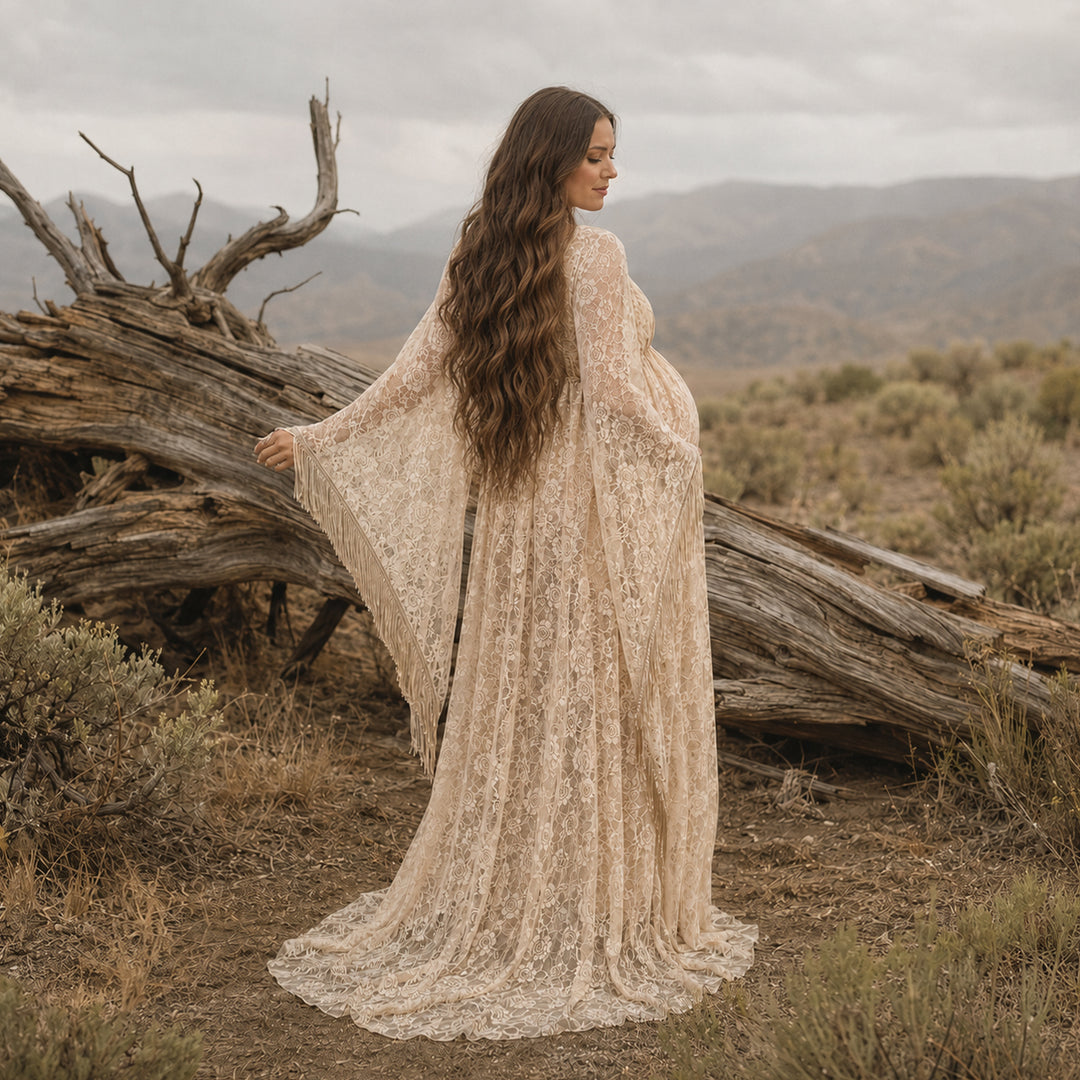 pregnant woman in a Pheme khaki lace fringe gown stands with back to camera before deadwood, showing sleeve fringe.