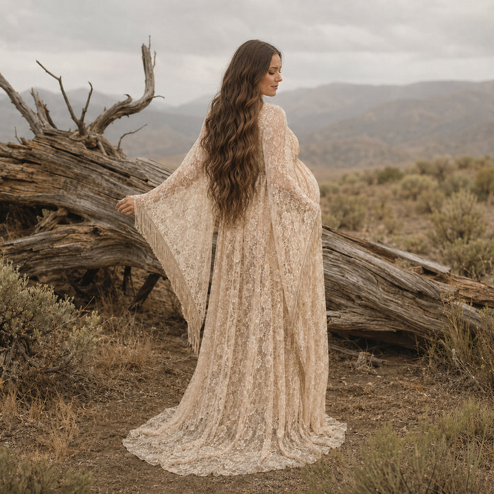 pregnant woman in a Pheme khaki lace fringe gown stands with back to camera before deadwood, showing sleeve fringe.